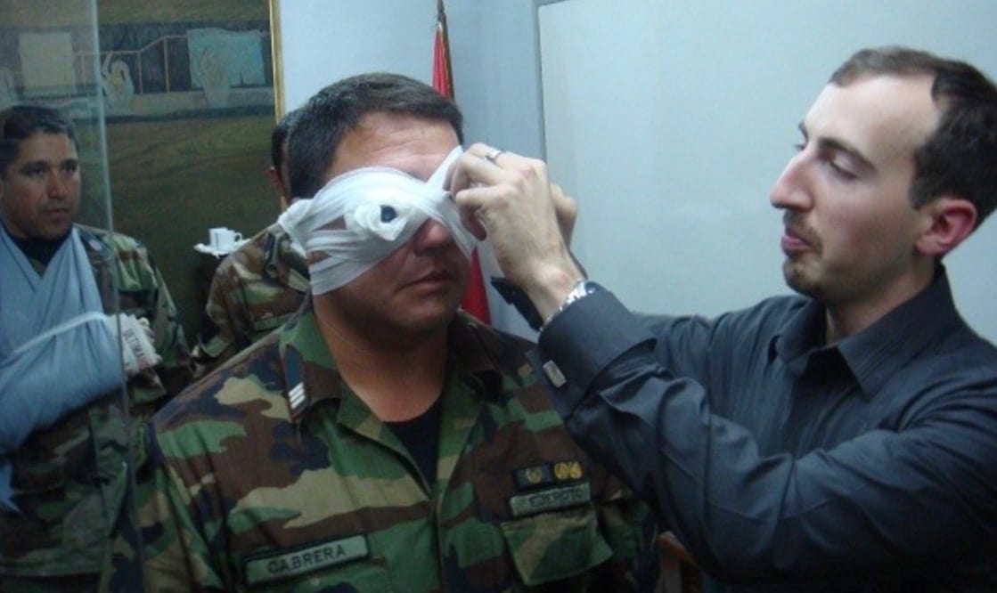 An instructor applying a bandage during a hands-on first aid drill