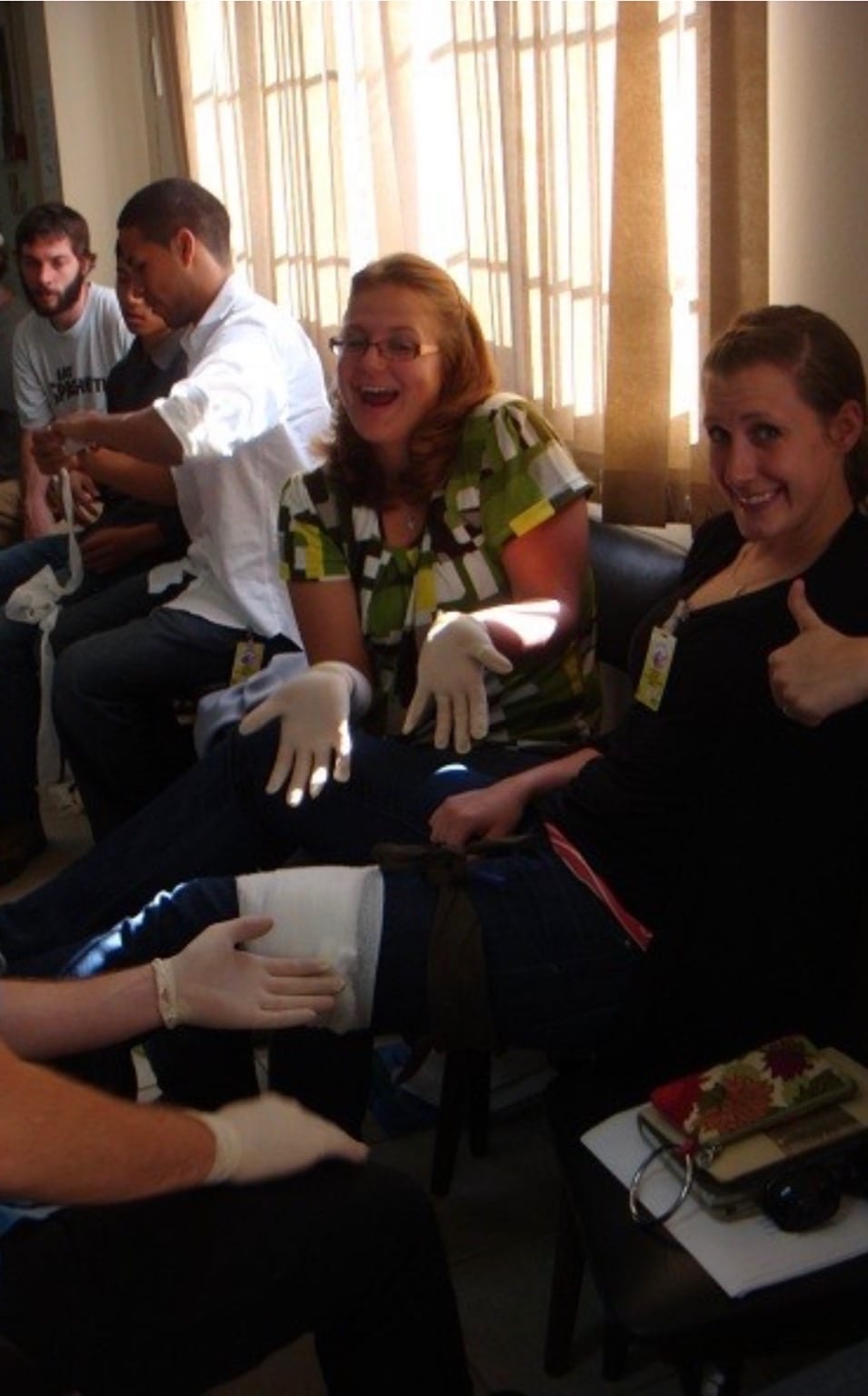 Students giving a thumbs up while practicing splinting and bandaging